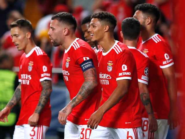 Benfica players celebrate an own goal by Paris Saint-Germain's Danilo Pereira on October 5, 2022