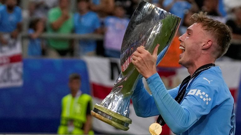Manchester City's Cole Palmer celebrates with trophy after winning the UEFA Super Cup Final soccer match between Manchester City and Sevilla at Georgios Karaiskakis stadium in Piraeus port, near Athens, Greece, Wednesday, Aug. 16, 2023. (AP Photo/Thanassis Stavrakis)