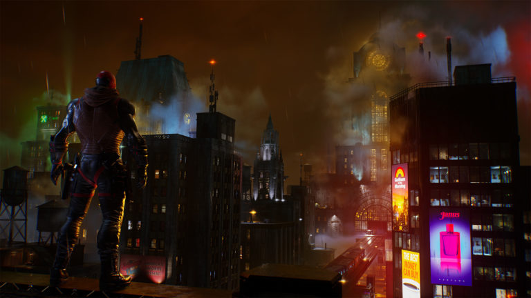 An image from Gotham Knights showing Red Hood facing a skyline of Gotham City at night, with his back to the camera