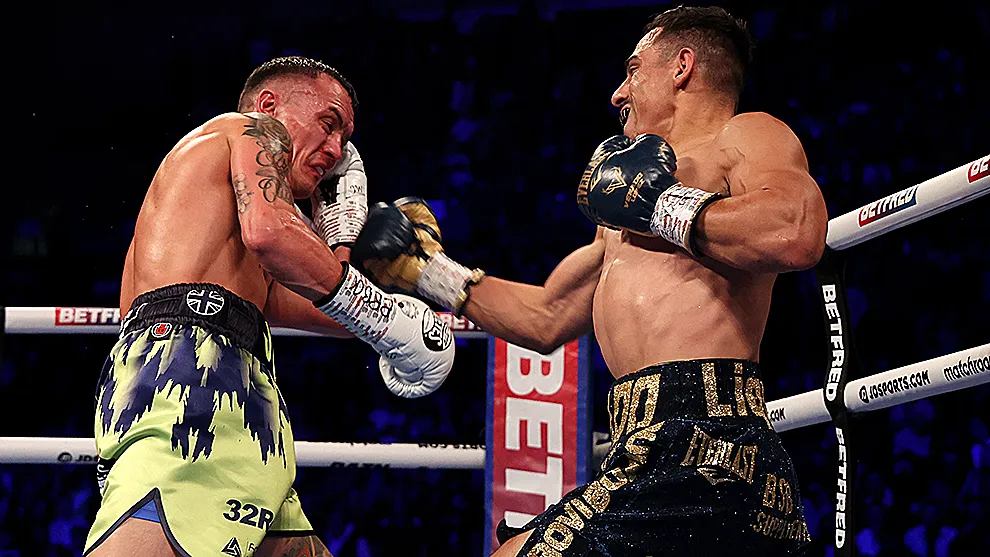 Josh Warrington and Luis Alberto Lopez exchange blows during their featherweight fight at First Direct Arena on December 10, 2022 in Leeds, England