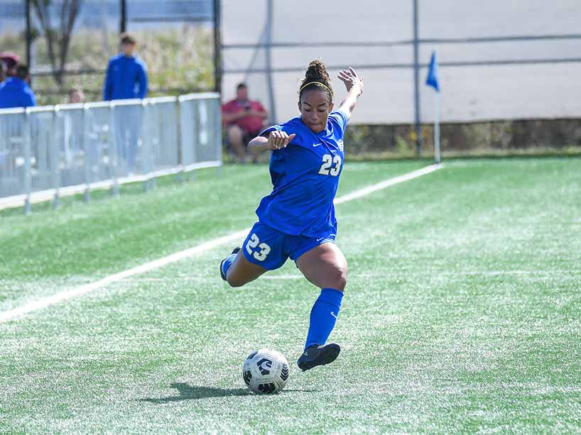 TMU Bold soccer player, Alexia Rhooms, kicks a soccer ball