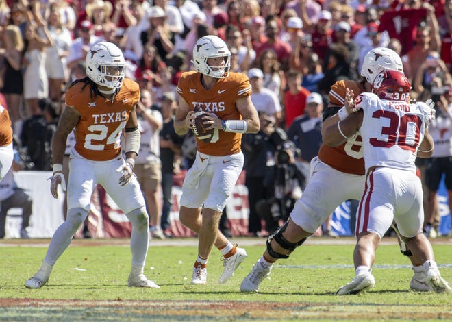 Oct 7, 2023; Dallas, Texas, USA; Texas Longhorns running back Jonathon Brooks (24) and quarterback Quinn Ewers (3) in action during the game between the Texas Longhorns and the Oklahoma Sooners at the Cotton Bowl. Mandatory Credit: Jerome Miron-USA TODAY Sports